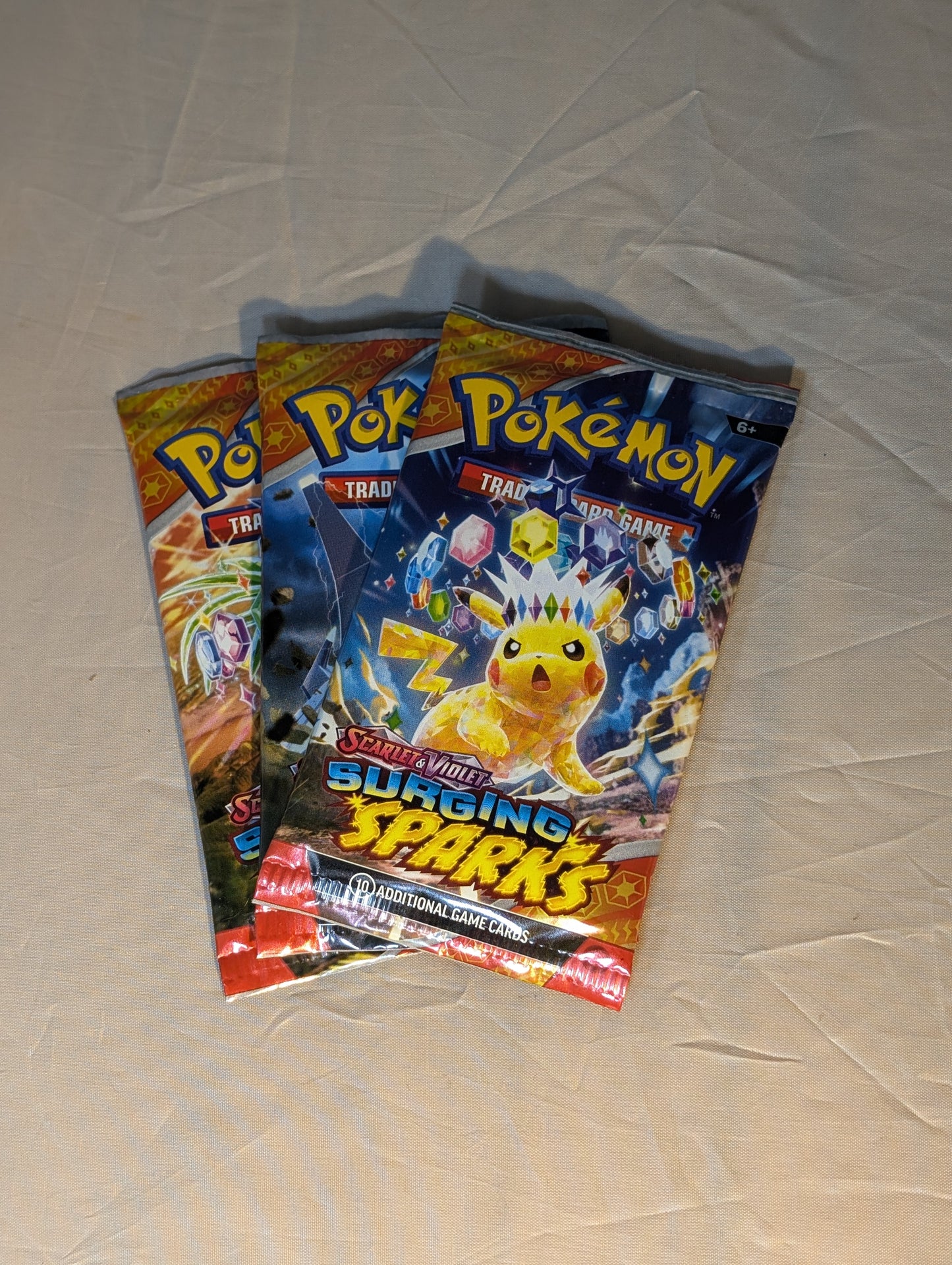 Pokemon Surging Sparks Booster Pack -3 Pack Combo